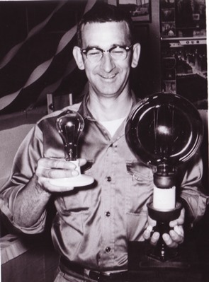 Grant Ayers with light bulbs, c. 1950s