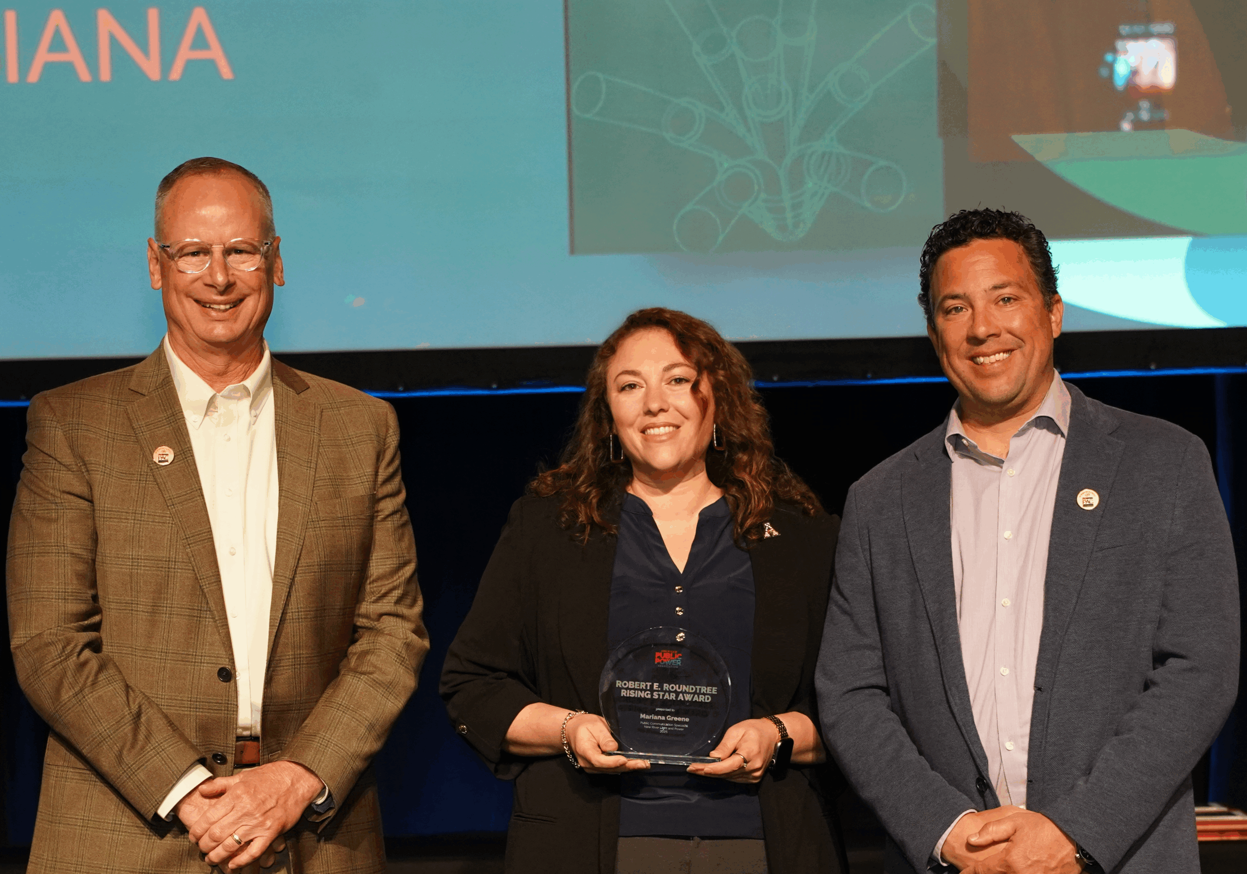 Award winner Mariana Greene, NRLP public communication specialist, center, pictured with John Harlow, left, CEO and general manager of Snohomish County PUD in Washington and chair-elect of the APPA’s Board of Directors and Nick Lawler, right, general manager of Littleton Electric Light & Power departments in Massachusetts and chair of the APPA’s Board of Directors.
