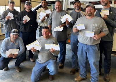 NRLP linemen hold thank you notes from local students